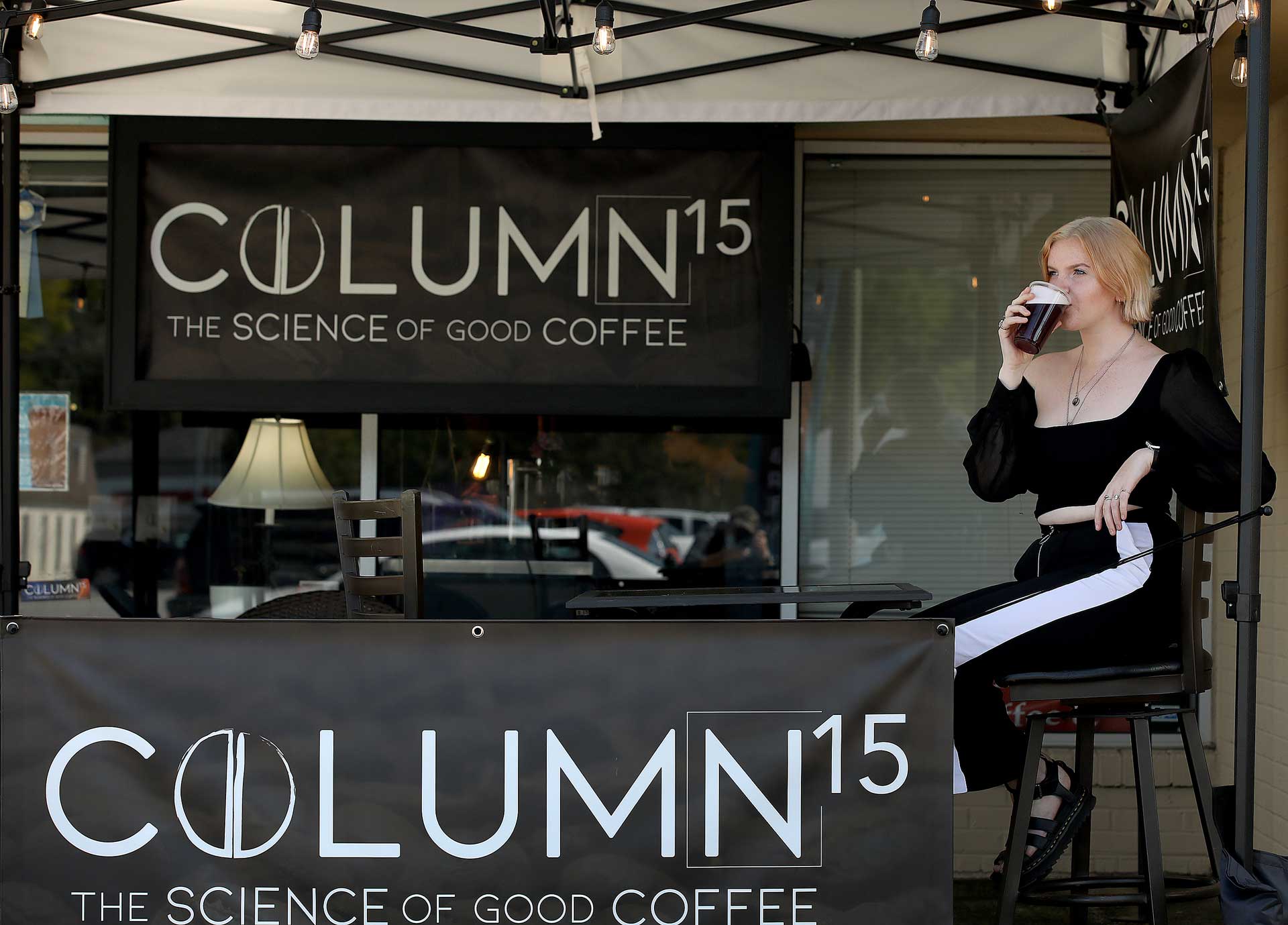 Enjoying unique coffee and tea beverages outside the Column 15 shop in the Edge District September 22, 2020.